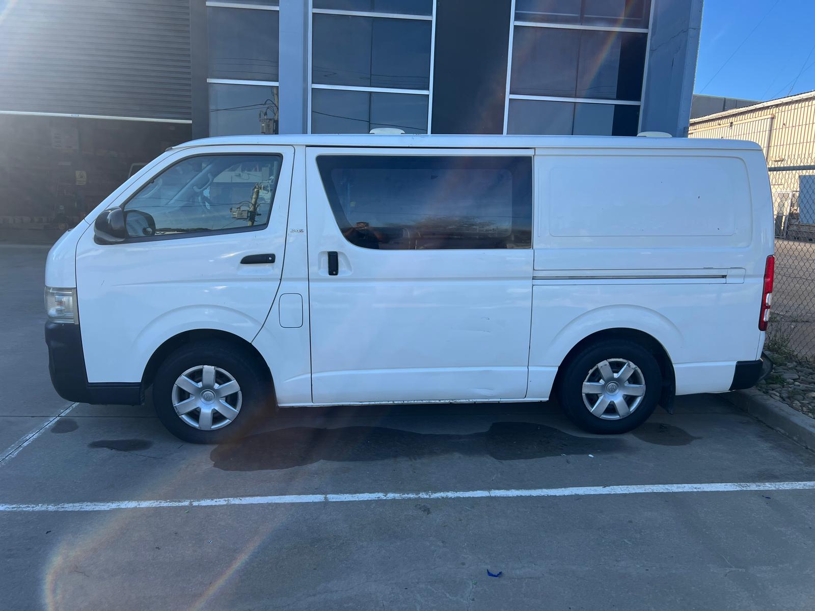 Commercial van undergoing professional vinyl sticker removal and detailing service in Melbourne