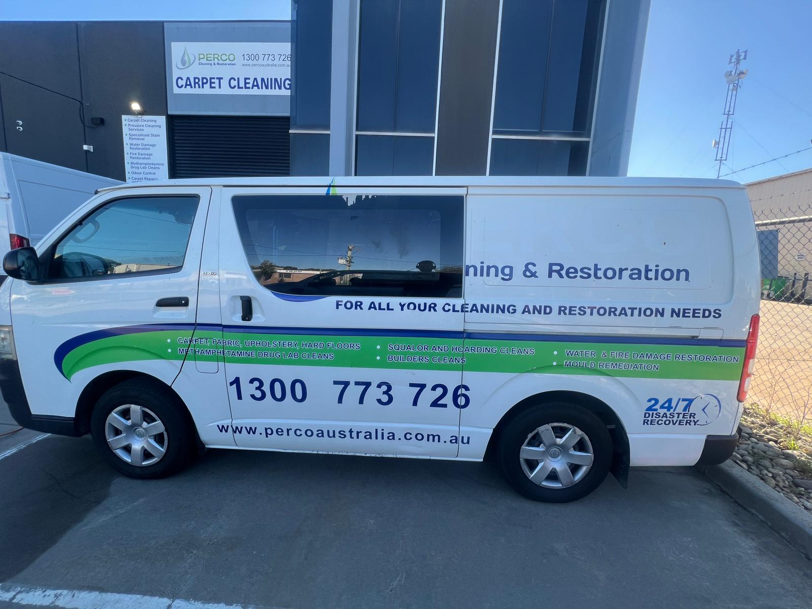 Professional mobile car detailing expert removing vinyl signage from commercial van in Melbourne