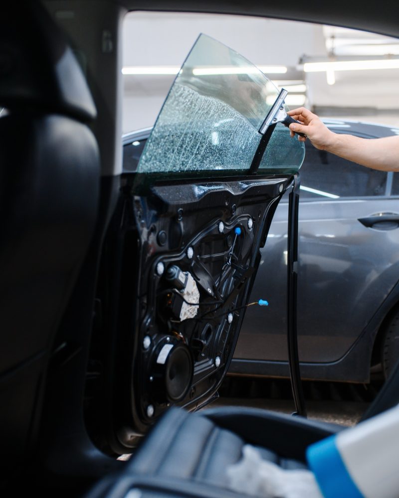 Worker prepares car for tinting, tuning service